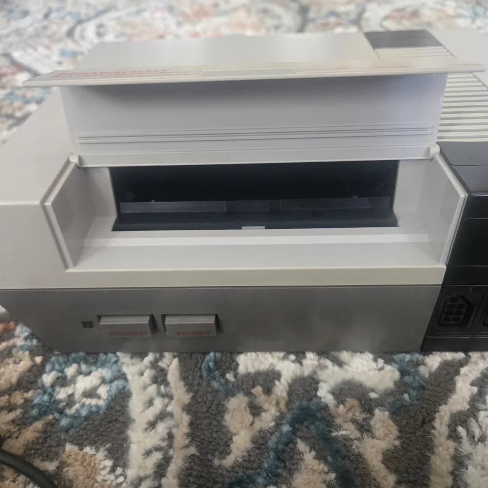 Nintendo Entertainment System with Gray and Black Controllers